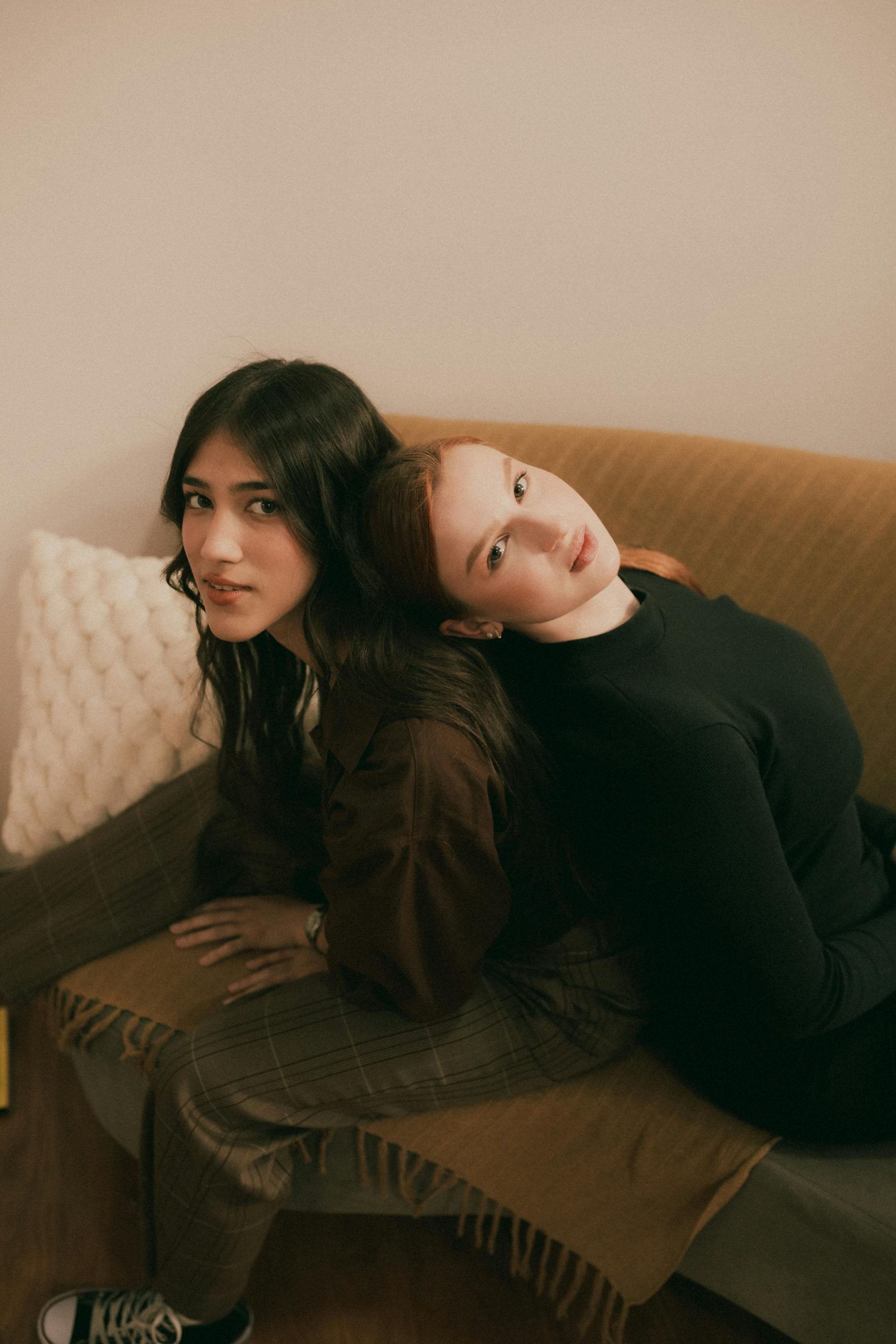 pexels-alexander-mass-748453803-27869817 Two women sitting close together, one comforting the other