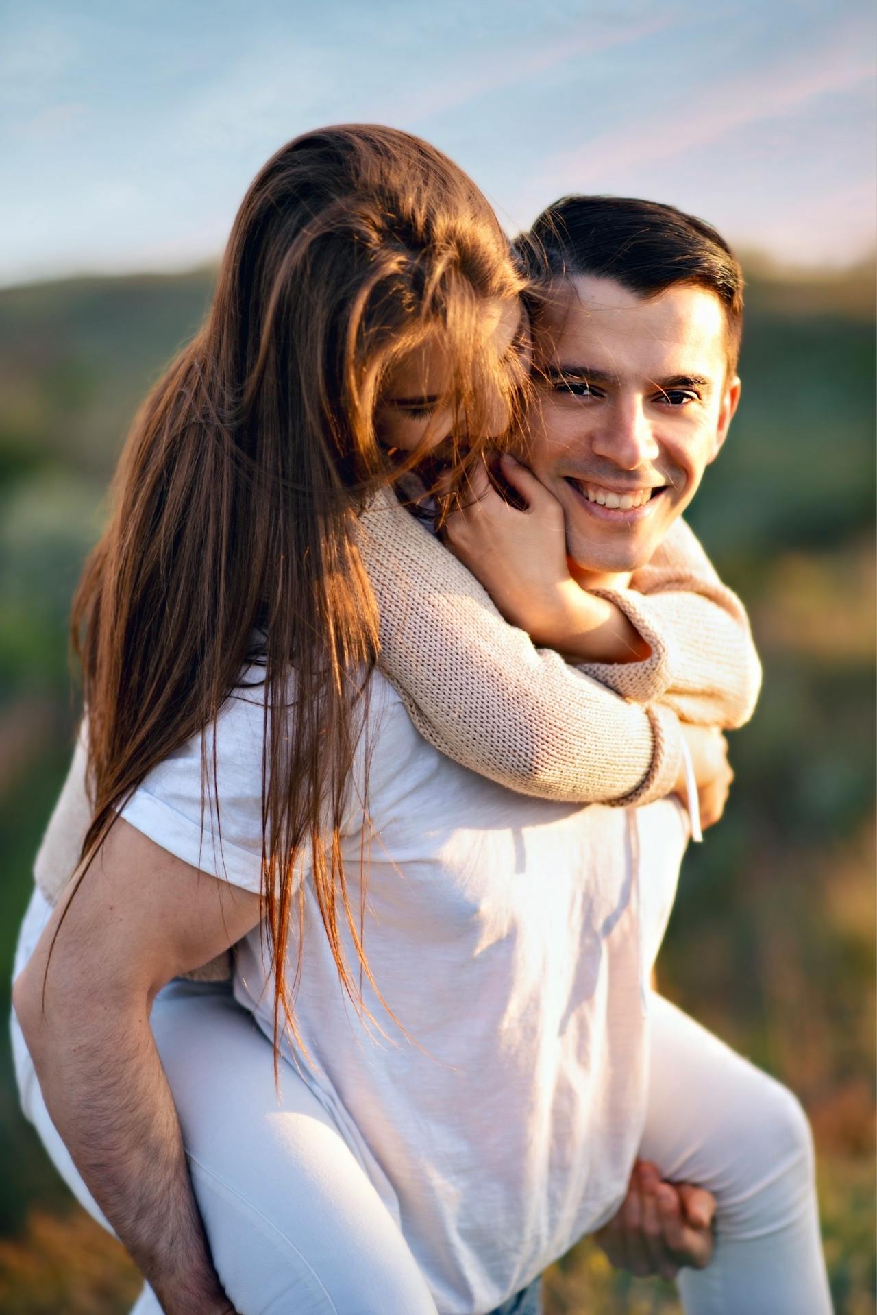 Happy Young Man Carrying a Woman on his Back A man carrying a woman on his back, both laughing
