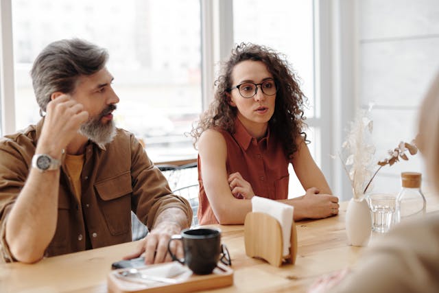 Two people in conversation across a table